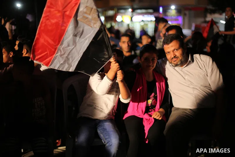 Palestinian fans watch the World Cup 2018 Africa qualifying football match between Egypt and Congo via large screens in Gaza City on October 8, 2017. Photo by Mohammed Asad