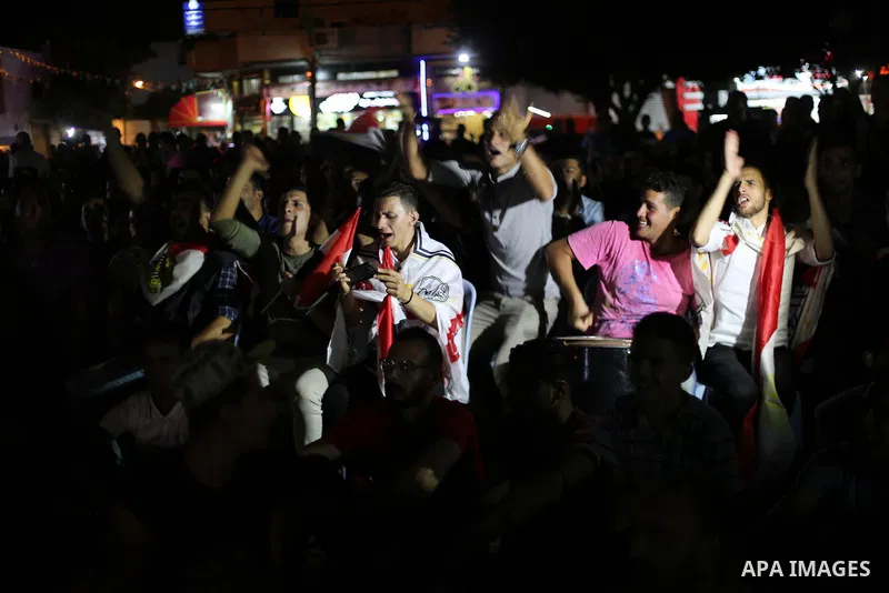 Palestinian fans watch the World Cup 2018 Africa qualifying football match between Egypt and Congo via large screens in Gaza City on October 8, 2017. Photo by Mohammed Asad