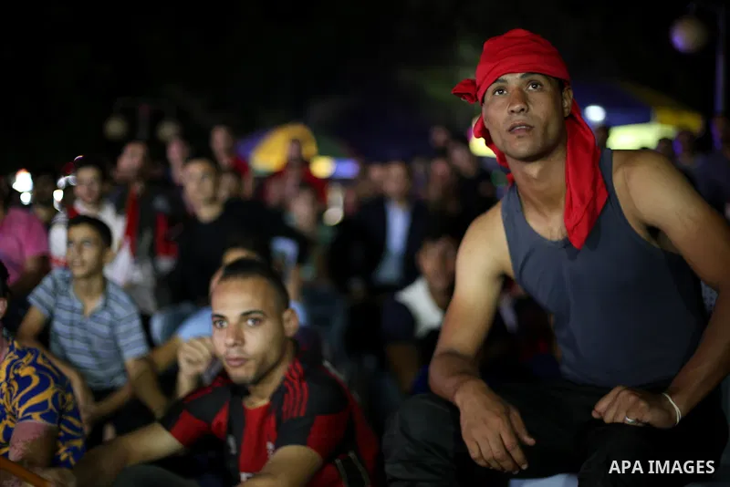 Palestinian fans watch the World Cup 2018 Africa qualifying football match between Egypt and Congo via large screens in Gaza City on October 8, 2017. Photo by Mohammed Asad
