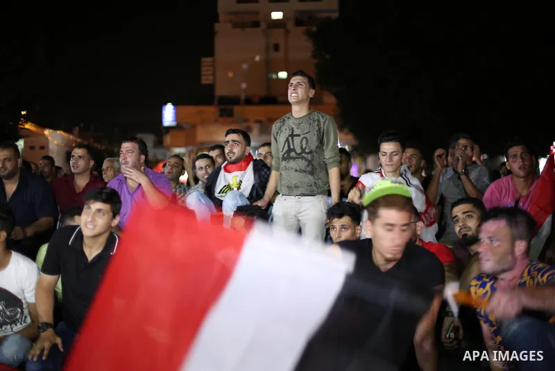Palestinian fans watch the World Cup 2018 Africa qualifying football match between Egypt and Congo via large screens in Gaza City on October 8, 2017. Photo by Mohammed Asad