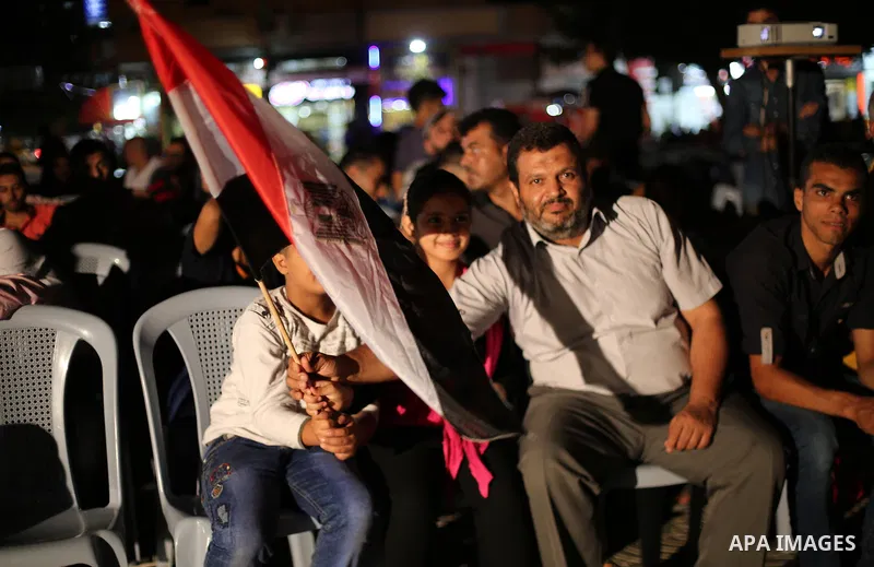Palestinian fans watch the World Cup 2018 Africa qualifying football match between Egypt and Congo via large screens in Gaza City on October 8, 2017. Photo by Mohammed Asad