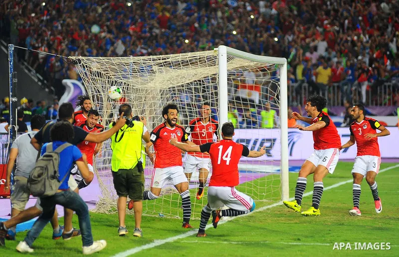 Egypt's team players celebrate wining after the 2018 FIFA World Cup qualification match between Egypt and Congo at the Borg El-Arab Stadium in Alexandria, Egypt, Oct. 8, 2017. Egypt won 2-1 and qualified to the World Cup...