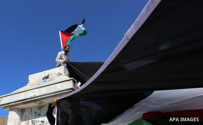 Palestinians wave the flags of Egypt, Palestine, Fatah and Hamas as they gather in Gaza City to celebrate after rival Palestinian factions Hamas and Fatah reached an agreement on ending a decade-long split following talk...