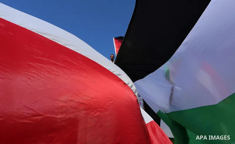 Palestinians wave the flags of Egypt, Palestine, Fatah and Hamas as they gather in Gaza City to celebrate after rival Palestinian factions Hamas and Fatah reached an agreement on ending a decade-long split following talk...