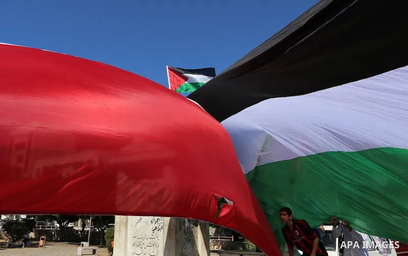 Palestinians wave the flags of Egypt, Palestine, Fatah and Hamas as they gather in Gaza City to celebrate after rival Palestinian factions Hamas and Fatah reached an agreement on ending a decade-long split following talk...
