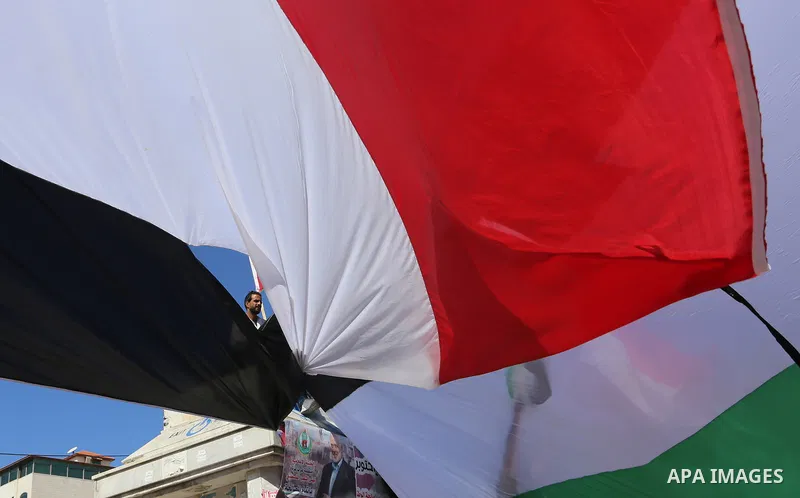 Palestinians wave the flags of Egypt, Palestine, Fatah and Hamas as they gather in Gaza City to celebrate after rival Palestinian factions Hamas and Fatah reached an agreement on ending a decade-long split following talk...