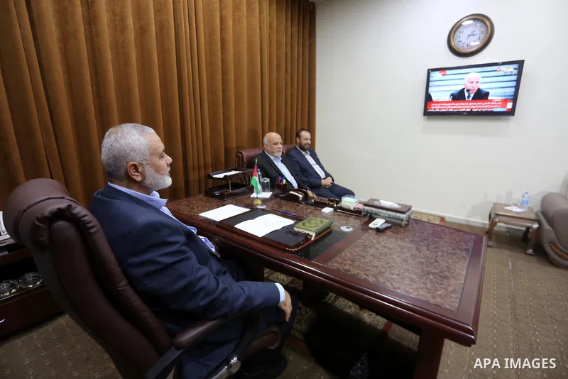 Hamas Chief Ismail Haniyeh watches a TV broadcast of a deal signing between Hamas and Fatah in Cairo, at his office in Gaza City October 12, 2017. Rival Palestinian factions Hamas and Fatah have reached agreement on aspe...