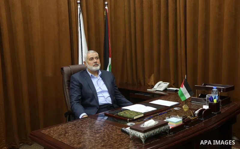 Hamas Chief Ismail Haniyeh watches a TV broadcast of a deal signing between Hamas and Fatah in Cairo, at his office in Gaza City October 12, 2017. Rival Palestinian factions Hamas and Fatah have reached agreement on aspe...