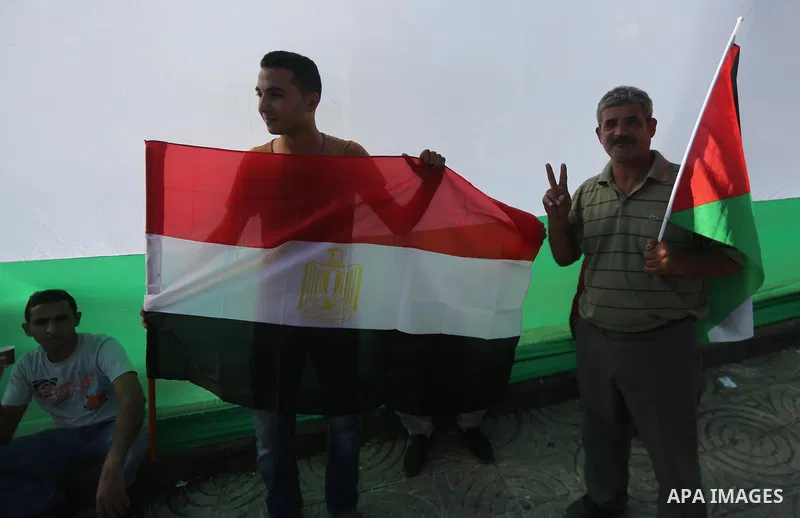Palestinians wave the flags of Egypt, Palestine, Fatah and Hamas as they gather in Gaza City to celebrate after rival Palestinian factions Hamas and Fatah reached an agreement on ending a decade-long split following talk...