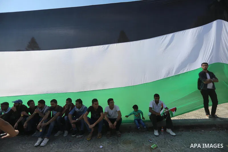 Palestinians wave the flags of Egypt, Palestine, Fatah and Hamas as they gather in Gaza City to celebrate after rival Palestinian factions Hamas and Fatah reached an agreement on ending a decade-long split following talk...