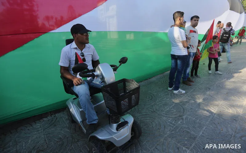 Palestinians wave the flags of Egypt, Palestine, Fatah and Hamas as they gather in Gaza City to celebrate after rival Palestinian factions Hamas and Fatah reached an agreement on ending a decade-long split following talk...