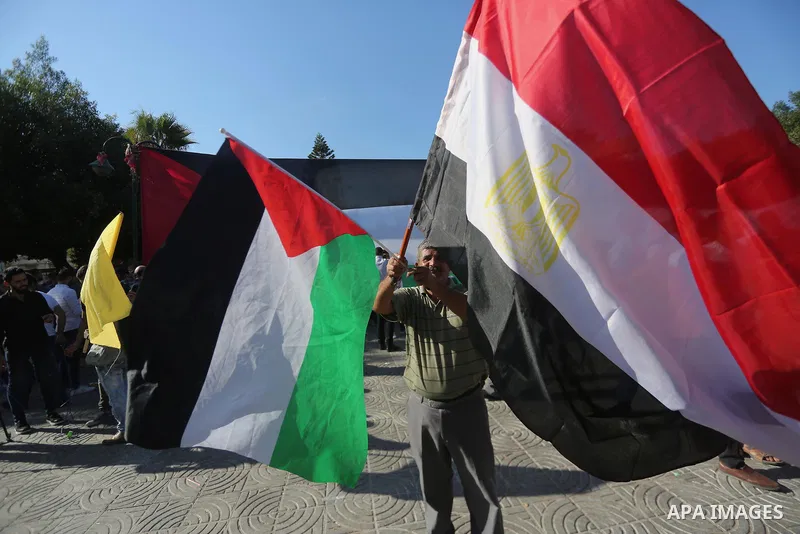 Palestinians wave the flags of Egypt, Palestine, Fatah and Hamas as they gather in Gaza City to celebrate after rival Palestinian factions Hamas and Fatah reached an agreement on ending a decade-long split following talk...