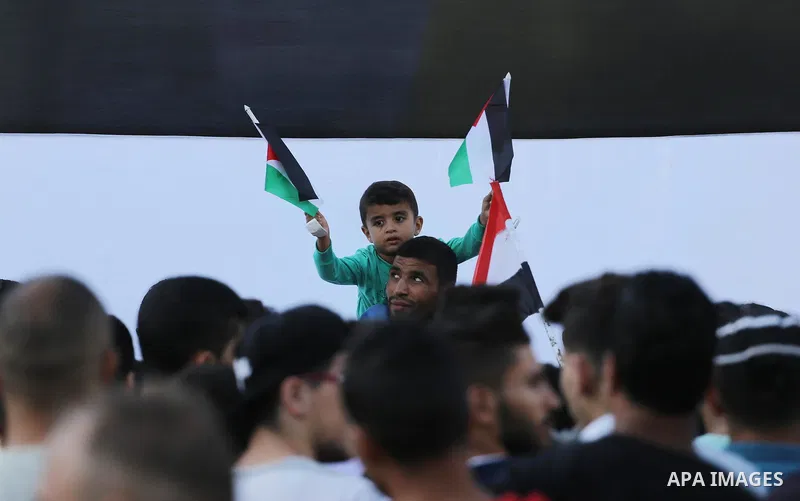 A group of people gather in front of the the Unknown Soldier's monument to celebrate after Hamas and Fatah have reached an agreement after talks held since Tuesday in the Egyptian capital of Cairo, in Gaza City, Gaza on...