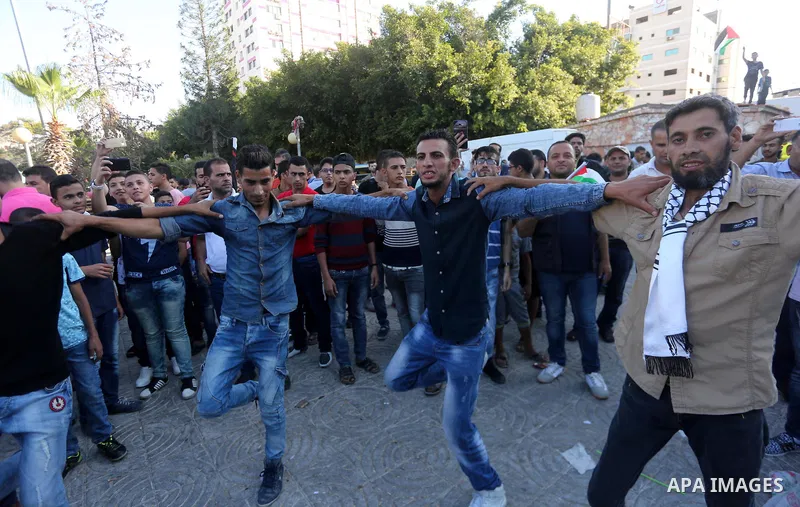 A group of people gather in front of the the Unknown Soldier's monument to celebrate after Hamas and Fatah have reached an agreement after talks held since Tuesday in the Egyptian capital of Cairo, in Gaza City, Gaza on...