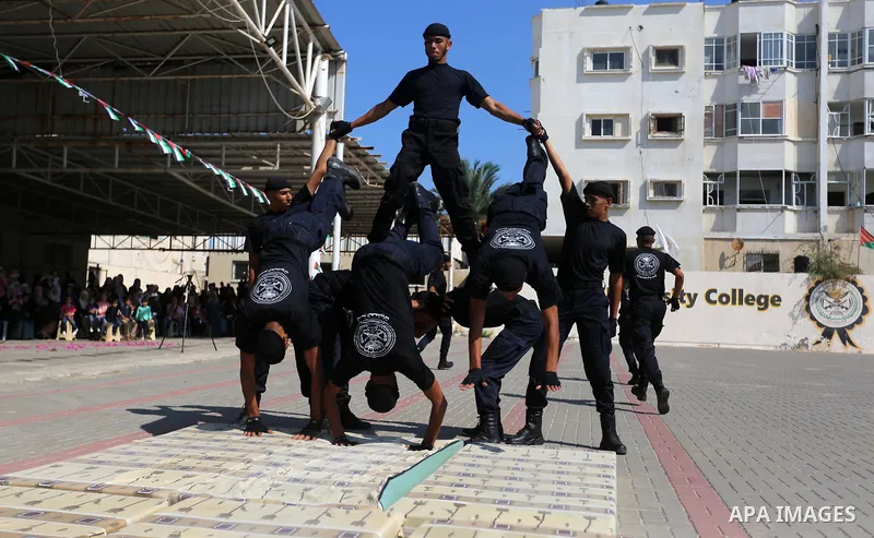 Palestinian students show off their military skills during a graduation ceremony from Ribat University College, in Gaza City, On October 16, 2017. Photo by Atia Darwish