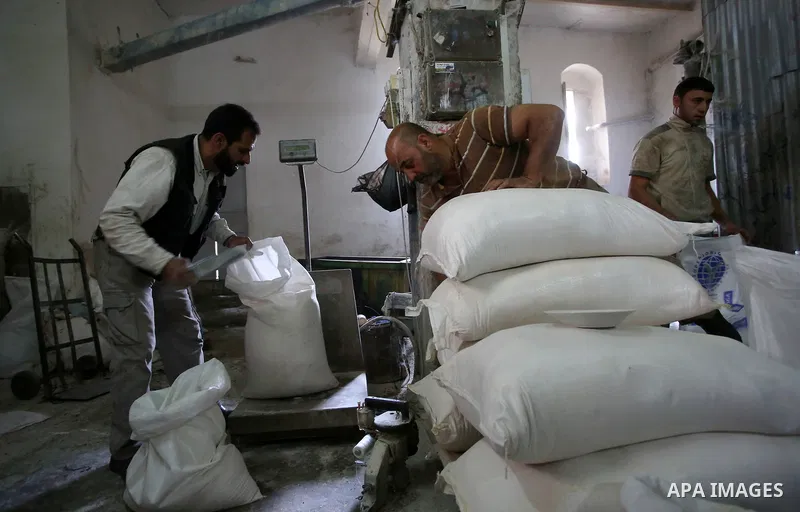 Palestinian laborers work at a Al-Adham old flour mill in the old town of West Bank city of Nablus October 10, 2017. Al-Adham mill Was founded in 1945 and grinds all kinds of grains, such as wheat, beans, chickpeas, on m...