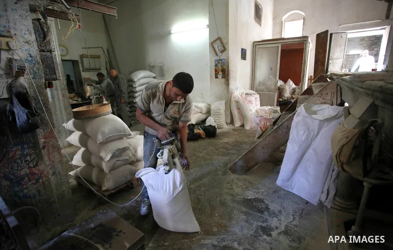 Palestinian laborers work at a Al-Adham old flour mill in the old town of West Bank city of Nablus October 10, 2017. Al-Adham mill Was founded in 1945 and grinds all kinds of grains, such as wheat, beans, chickpeas, on m...