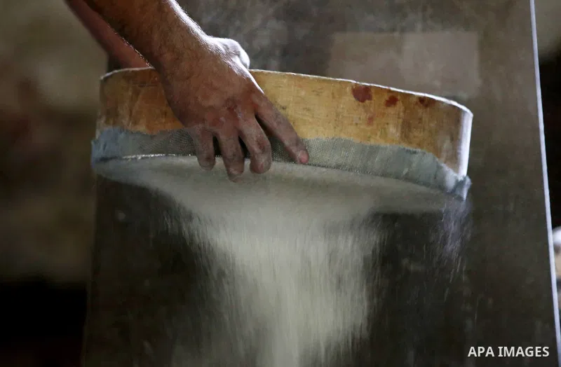 Palestinian laborers work at a Al-Adham old flour mill in the old town of West Bank city of Nablus October 10, 2017. Al-Adham mill Was founded in 1945 and grinds all kinds of grains, such as wheat, beans, chickpeas, on m...
