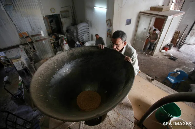 Palestinian laborers work at a Al-Adham old flour mill in the old town of West Bank city of Nablus October 10, 2017. Al-Adham mill Was founded in 1945 and grinds all kinds of grains, such as wheat, beans, chickpeas, on m...