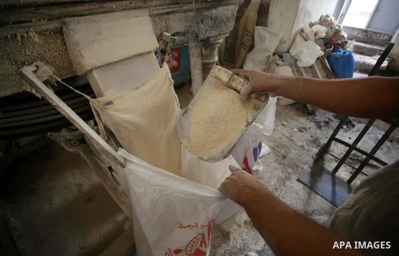 Palestinian laborers work at a Al-Adham old flour mill in the old town of West Bank city of Nablus October 10, 2017. Al-Adham mill Was founded in 1945 and grinds all kinds of grains, such as wheat, beans, chickpeas, on m...