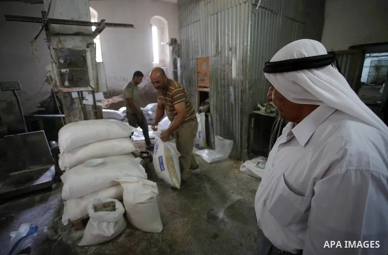 Palestinian laborers work at a Al-Adham old flour mill in the old town of West Bank city of Nablus October 10, 2017. Al-Adham mill Was founded in 1945 and grinds all kinds of grains, such as wheat, beans, chickpeas, on m...