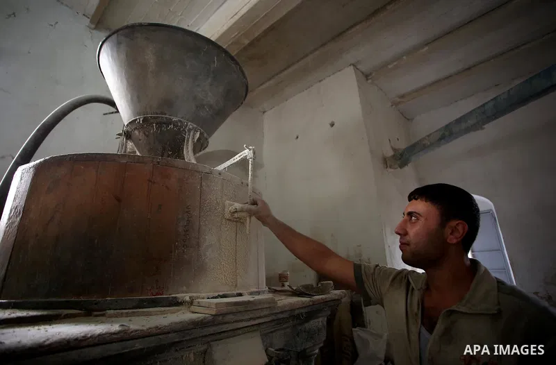 Palestinian laborers work at a Al-Adham old flour mill in the old town of West Bank city of Nablus October 10, 2017. Al-Adham mill Was founded in 1945 and grinds all kinds of grains, such as wheat, beans, chickpeas, on m...