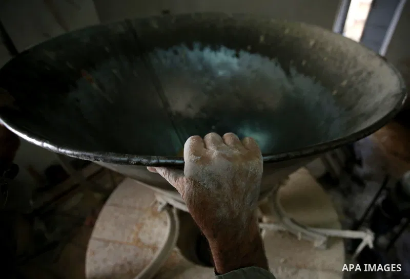 Palestinian laborers work at a Al-Adham old flour mill in the old town of West Bank city of Nablus October 10, 2017. Al-Adham mill Was founded in 1945 and grinds all kinds of grains, such as wheat, beans, chickpeas, on m...
