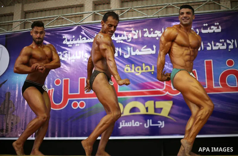 Palestinian participants pose during a bodybuilding competition, which organized by Palestinian Federation of Bodybuilding and Fitness (PFBB), in Gaza city on October 20, 2017. Photo by Mohammed Asad