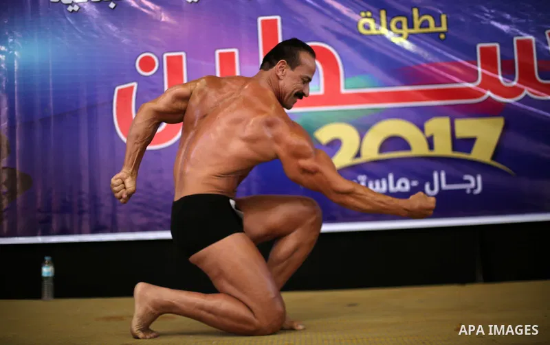 A Palestinian participant poses during a bodybuilding competition, which organized by Palestinian Federation of Bodybuilding and Fitness (PFBB), in Gaza city on October 20, 2017. Photo by Mohammed Asad