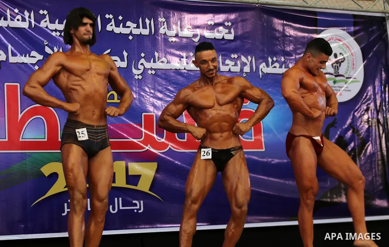 Palestinian participants pose during a bodybuilding competition, which organized by Palestinian Federation of Bodybuilding and Fitness (PFBB), in Gaza city on October 20, 2017. Photo by Mohammed Asad