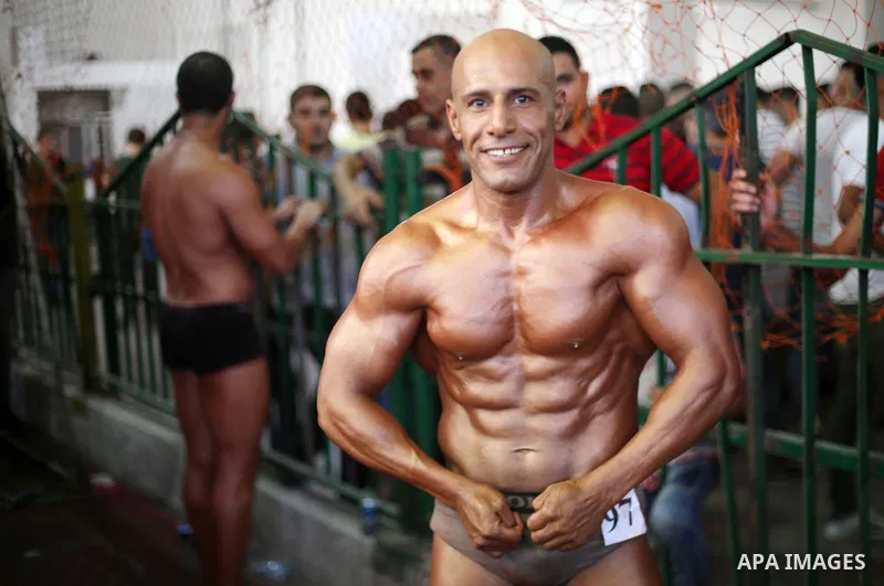 A Palestinian participant poses during a bodybuilding competition, which organized by Palestinian Federation of Bodybuilding and Fitness (PFBB), in Gaza city on October 20, 2017. Photo by Mohammed Asad