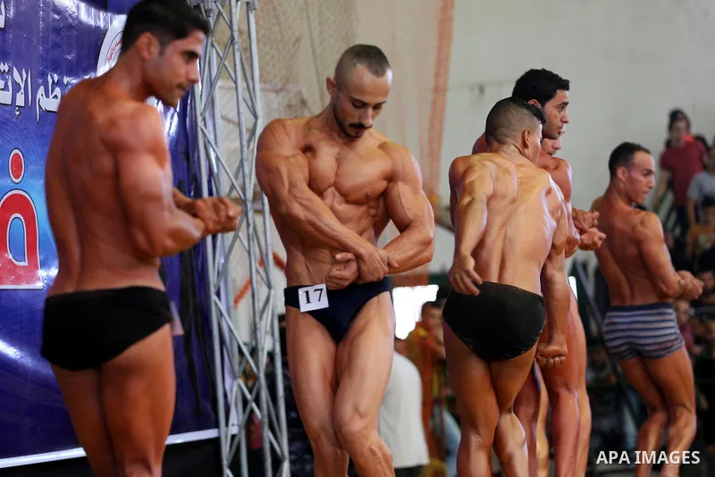Palestinian participants pose during a bodybuilding competition, which organized by Palestinian Federation of Bodybuilding and Fitness (PFBB), in Gaza city on October 20, 2017. Photo by Mohammed Asad