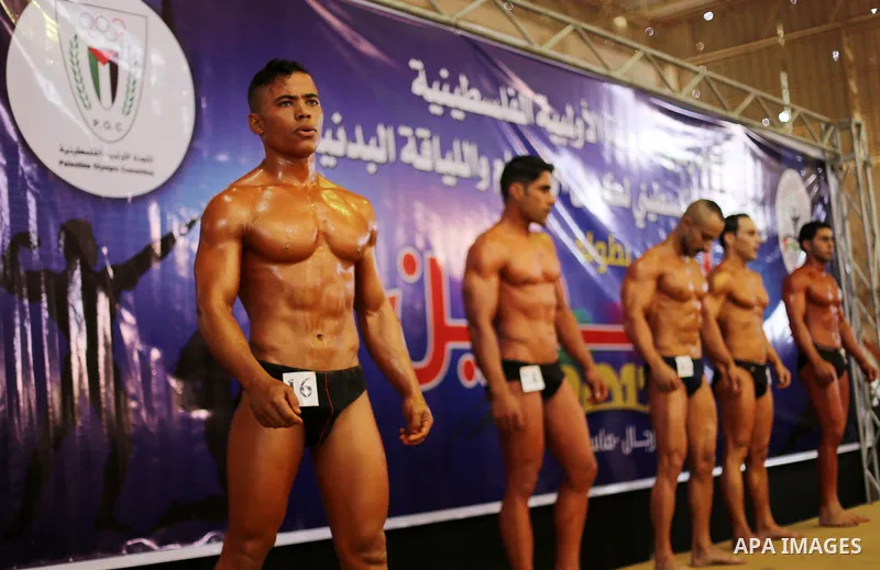 Palestinian participants pose during a bodybuilding competition, which organized by Palestinian Federation of Bodybuilding and Fitness (PFBB), in Gaza city on October 20, 2017. Photo by Mohammed Asad