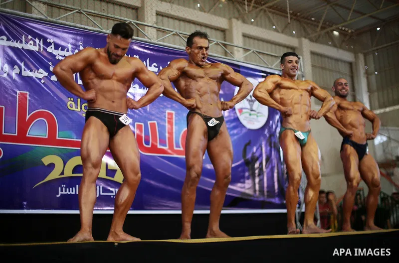 Palestinian participants pose during a bodybuilding competition, which organized by Palestinian Federation of Bodybuilding and Fitness (PFBB), in Gaza city on October 20, 2017. Photo by Mohammed Asad
