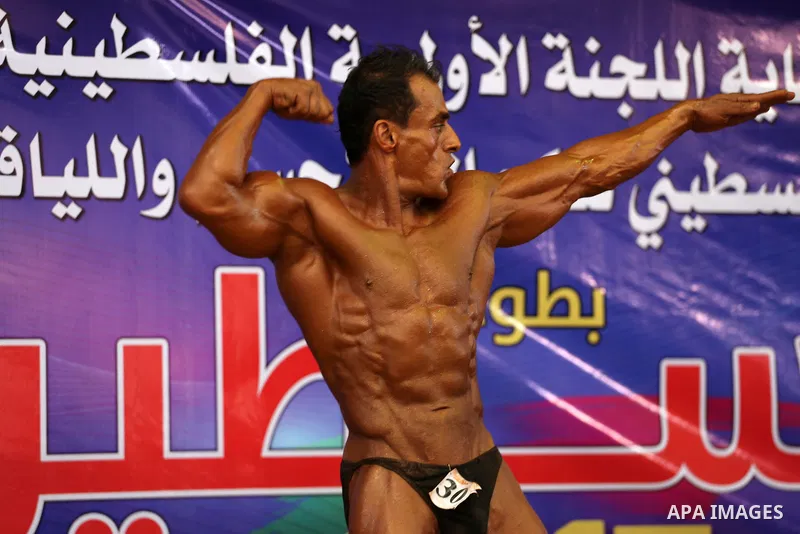 A Palestinian participant poses during a bodybuilding competition, which organized by Palestinian Federation of Bodybuilding and Fitness (PFBB), in Gaza city on October 20, 2017. Photo by Mohammed Asad