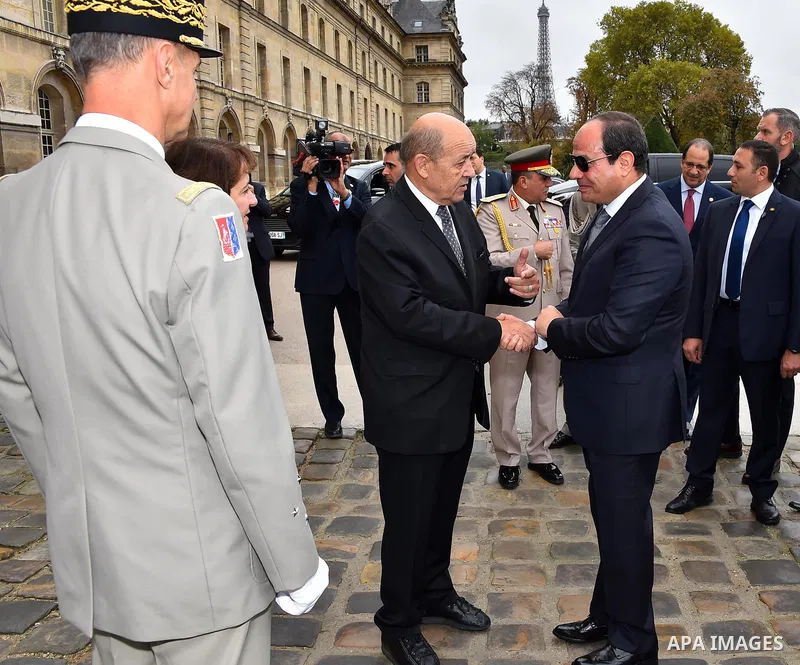 Egypt's President Abdel Fattah al-Sisi shakes hands with French Foreign Affairs Minister Jean-Yves Le Drian at the Hotel National des Invalides in Paris on October 24, 2017. Photo by Egyptian President Office