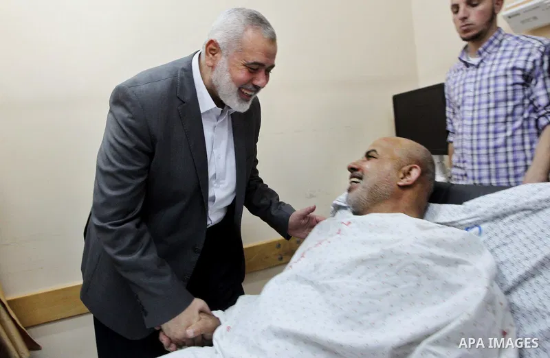 Hamas Chief Ismail Haniya visits Tawfiq Abu Naim, director general of the internal security forces, at a hospital in Gaza City. The head of Hamas security forces in the Gaza Strip was injured a day earlier when his car e...