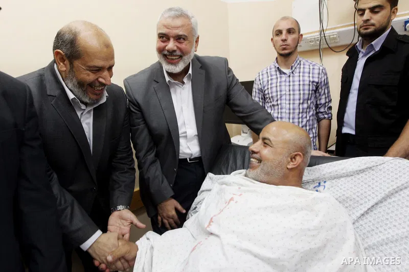 Hamas Chief Ismail Haniya visits Tawfiq Abu Naim, director general of the internal security forces, at a hospital in Gaza City. The head of Hamas security forces in the Gaza Strip was injured a day earlier when his car e...