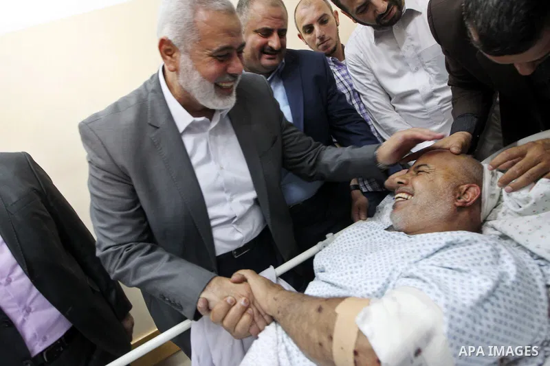Hamas Chief Ismail Haniya visits Tawfiq Abu Naim, director general of the internal security forces, at a hospital in Gaza City. The head of Hamas security forces in the Gaza Strip was injured a day earlier when his car e...