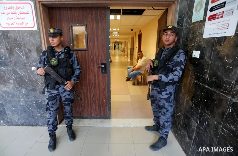 Palestinian security forces stand guards outside al-Shifa hospital where Tawfiq Abu Naim, director general of the internal security forces is recovering after he was wounded in a car bombing, in Gaza City October 27, 201...
