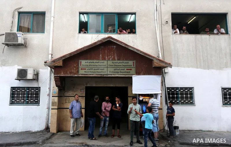 Palestinians stand outside al-Shifa hospital where Tawfiq Abu Naim, director general of the internal security forces is recovering after he was wounded in a car bombing, in Gaza City October 27, 2017. The head of Hamas s...