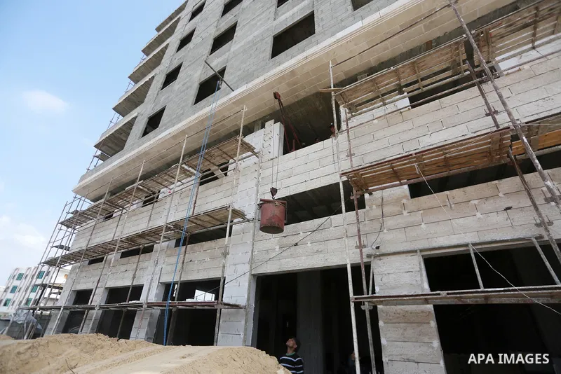 Palestinian laborers construction work at building still under construction, in Gaza city on October 28, 2017. Property owners in the Gaza Strip suffer from weak market and sales, and according to World Bank's report Gaz...