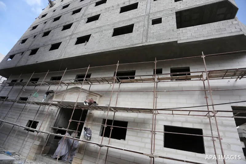 Palestinian laborers construction work at building still under construction, in Gaza city on October 28, 2017. Property owners in the Gaza Strip suffer from weak market and sales, and according to World Bank's report Gaz...