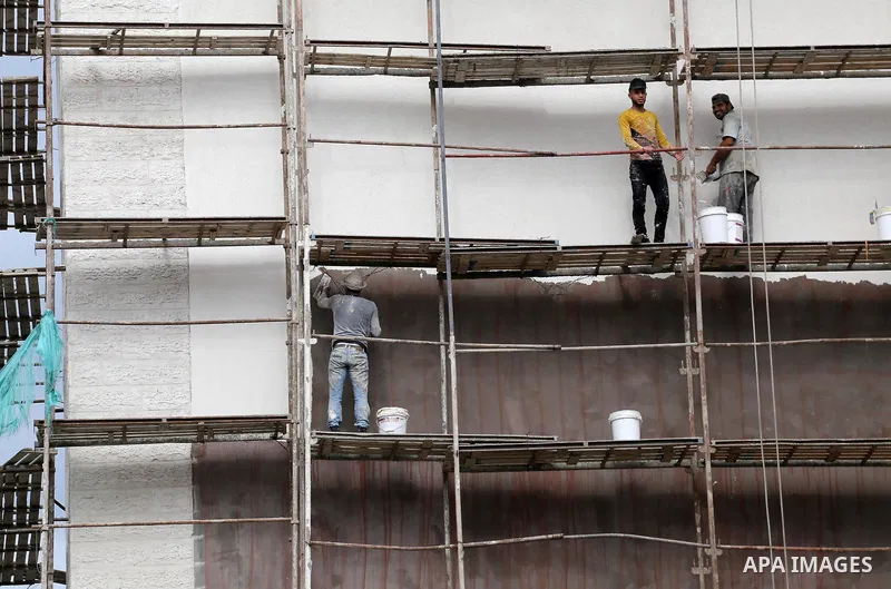 Palestinian laborers construction work at building still under construction, in Gaza city on October 28, 2017. Property owners in the Gaza Strip suffer from weak market and sales, and according to World Bank's report Gaz...