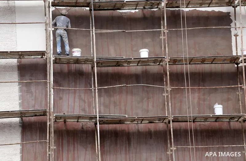 Palestinian laborers construction work at building still under construction, in Gaza city on October 28, 2017. Property owners in the Gaza Strip suffer from weak market and sales, and according to World Bank's report Gaz...