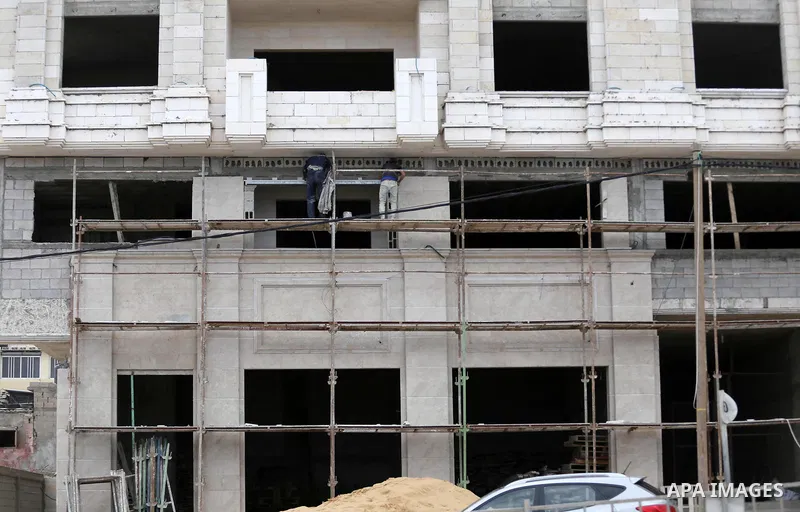 Palestinian laborers construction work at building still under construction, in Gaza city on October 28, 2017. Property owners in the Gaza Strip suffer from weak market and sales, and according to World Bank's report Gaz...