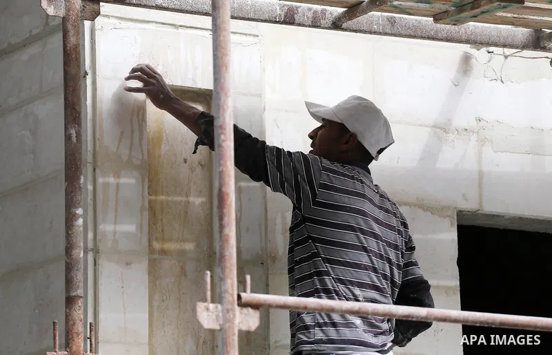 Palestinian laborers construction work at building still under construction, in Gaza city on October 28, 2017. Property owners in the Gaza Strip suffer from weak market and sales, and according to World Bank's report Gaz...