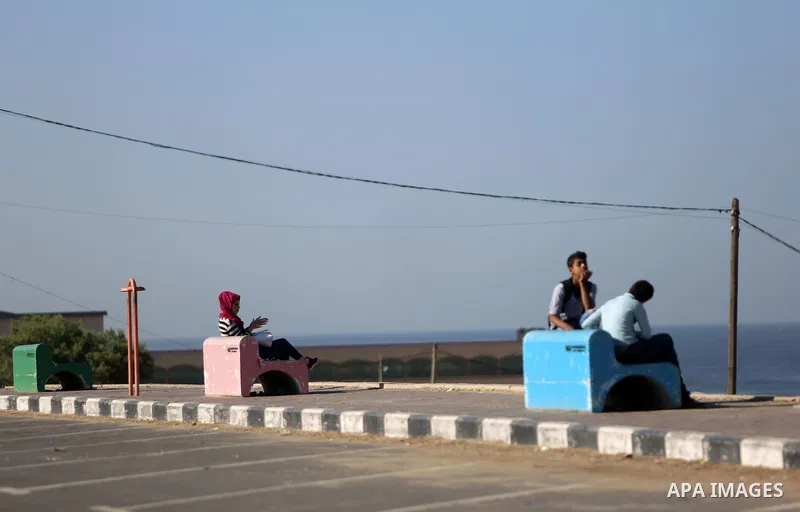 Palestinians sit at the beach of Gaza sea on October 29, 2017. Photo by Atia Darwish