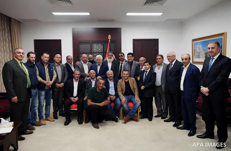 Palestinian President Mahmoud Abbas meets with members of popular committees for camps at his headquarters in the West Bank city of Ramallah on October 29, 2017. Photo by Thaer Ganaim