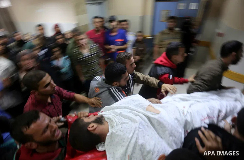 The body of Palestinian Marwan Alagha,22, is carried by mourners after he was killed when Israel blew up what it said was a tunnel stretching from the Gaza Strip into its territory, at Naser hospital in Khan Yunis, in th...